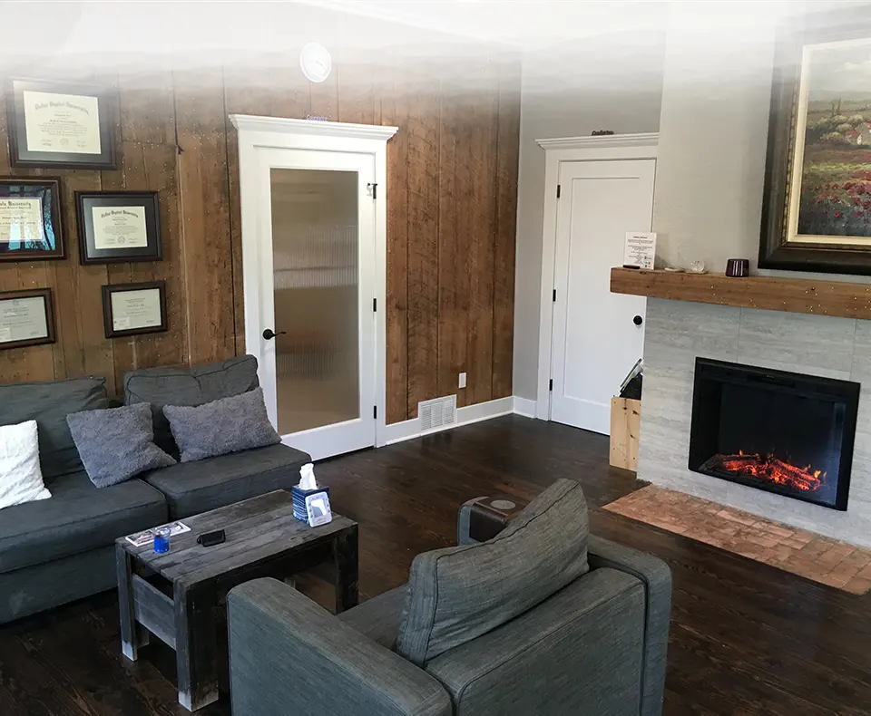 A living room with couches and a fireplace